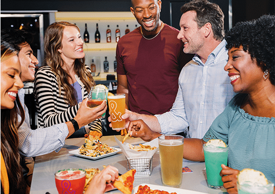 team eating and drinking together at dave and busters in nyc