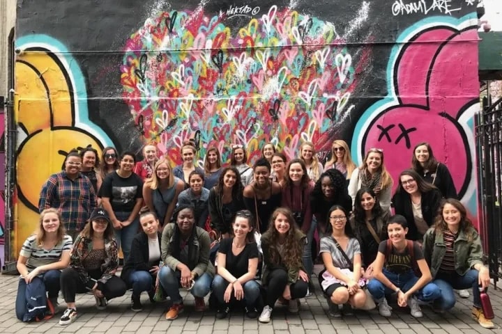 team in front of mural during nyc team building graffiti tour