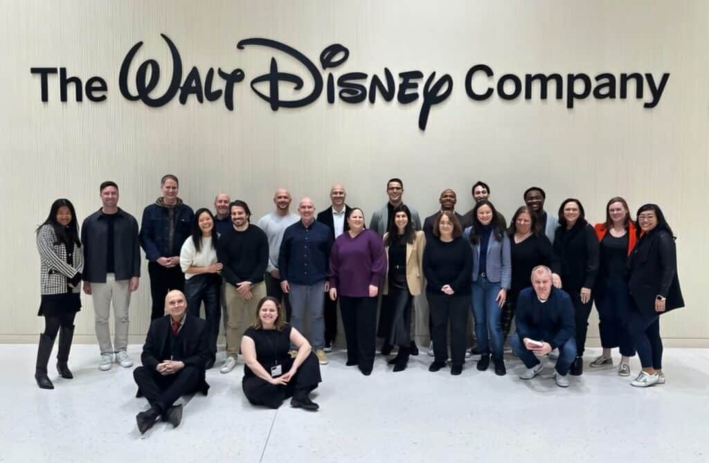 team in front of sign during nyc team building improv class