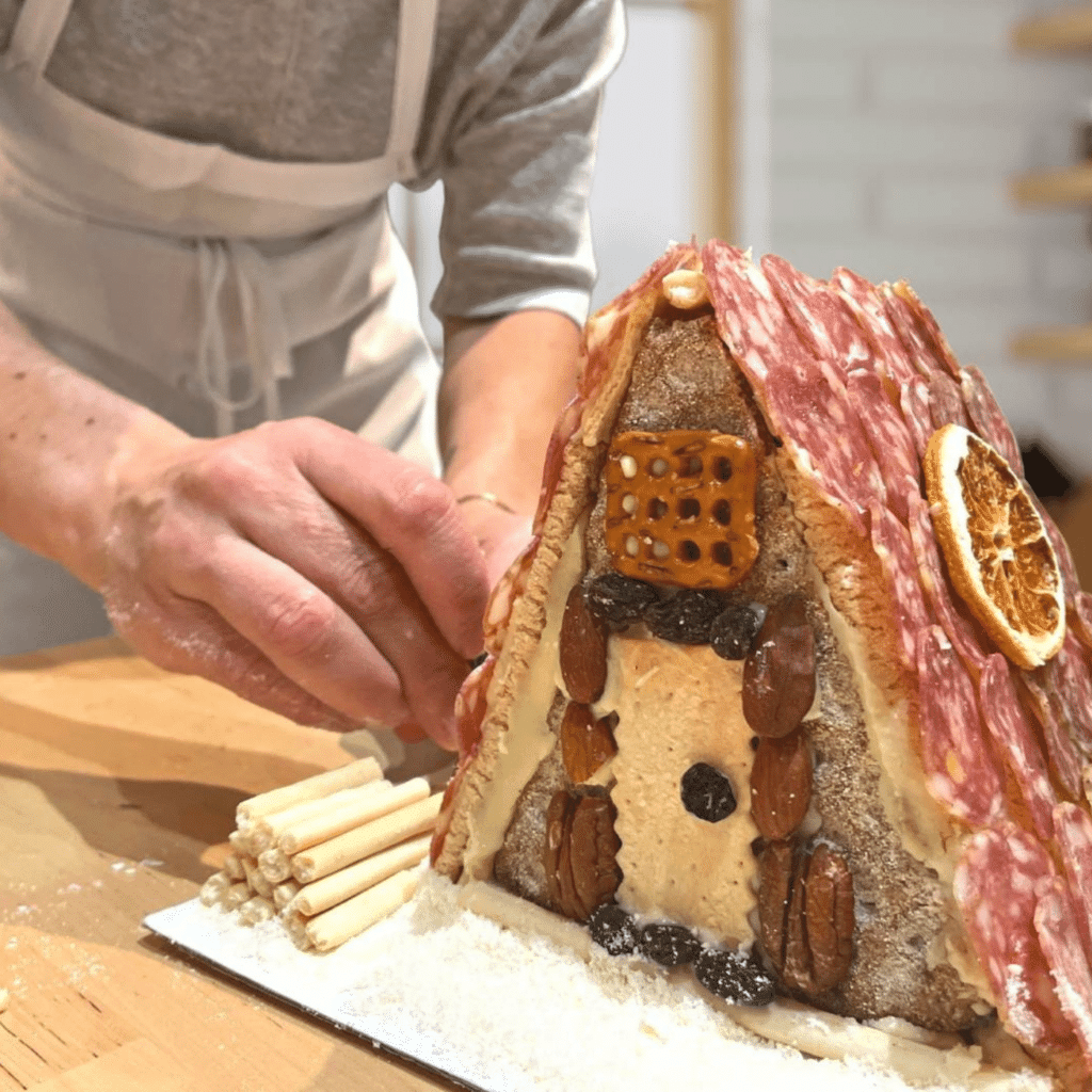 Edible Architecture. Hands Making A-Frame Charcuterie Chalet (1)