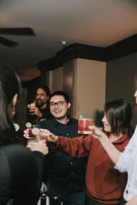 group toasting cocktails during avital interactive meal
