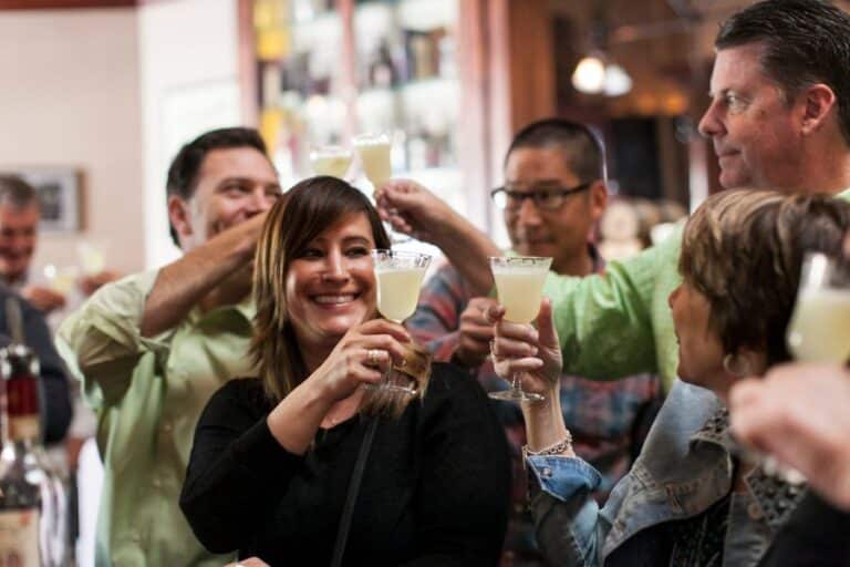 group toasting pisco punch cocktails during north beach food tour