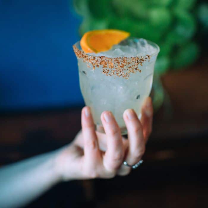 hand serving margarita during avital experience