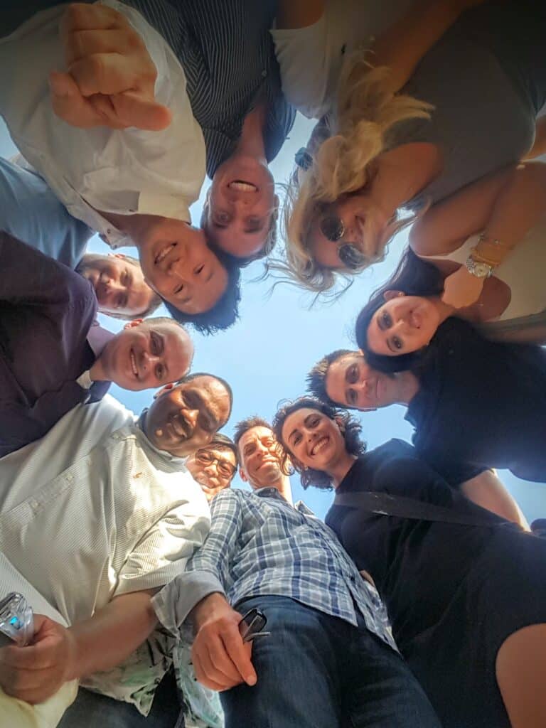 team looking down at camera during corporate team building event
