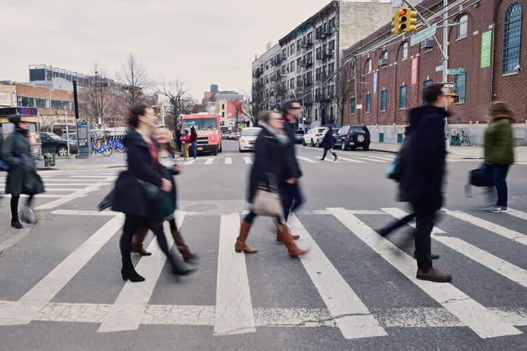 group crossing street during best nyc walking food tours