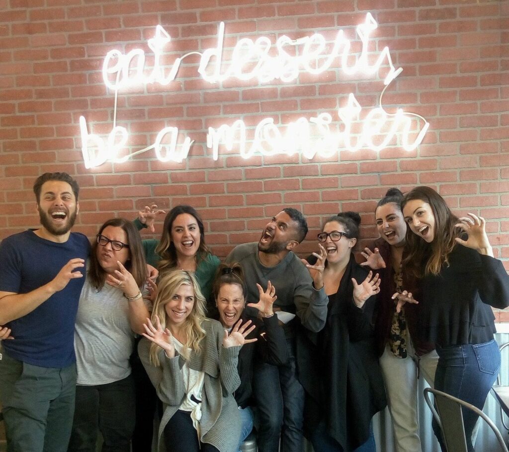 koreatown food tour guest in front restaurant sign, one of best corporate holiday party ideas in los angeles