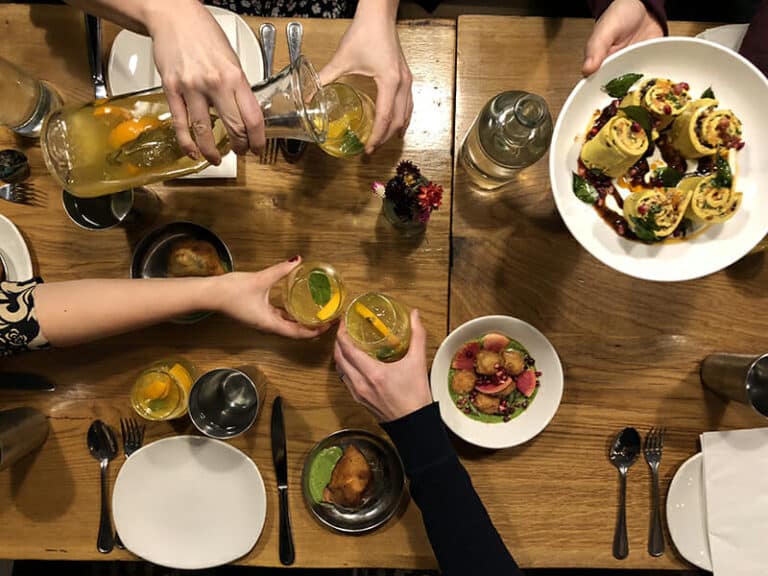 birdseye shot of group enjoying nyc team building food tour at table