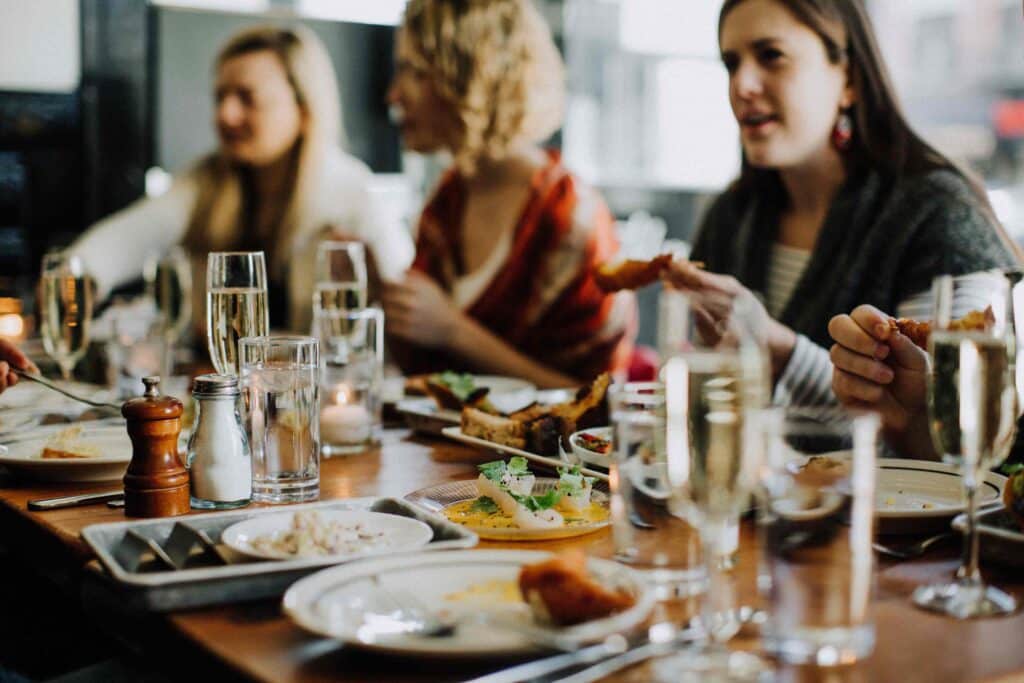 women sitting at table during bachelorette party food tours