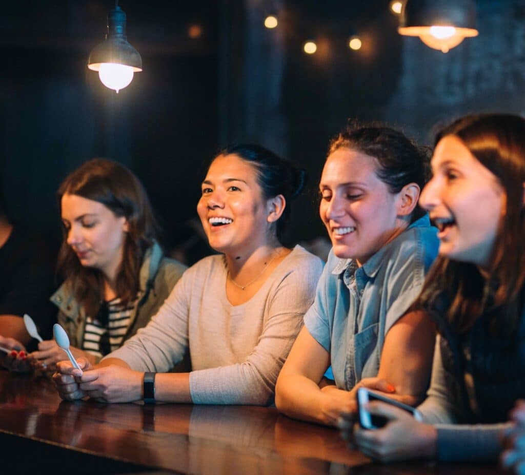 women sitting at bar during bachelorette party food tours