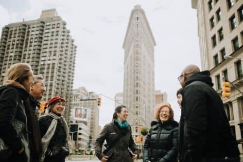 group standing outside flatiron building during nyc team building activities with avital food & drink experiences