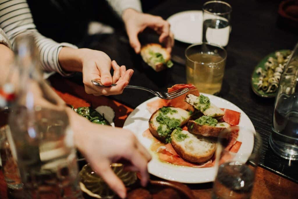 hands eating food on table during private dining experience