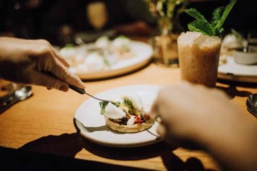 handing cutting dish during michelin food tour in san francisco to celebrate 30th birthday party