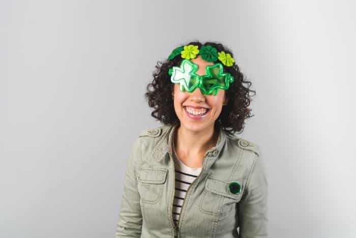 woman in shamrock glasses for team building activities for st. patrick's day