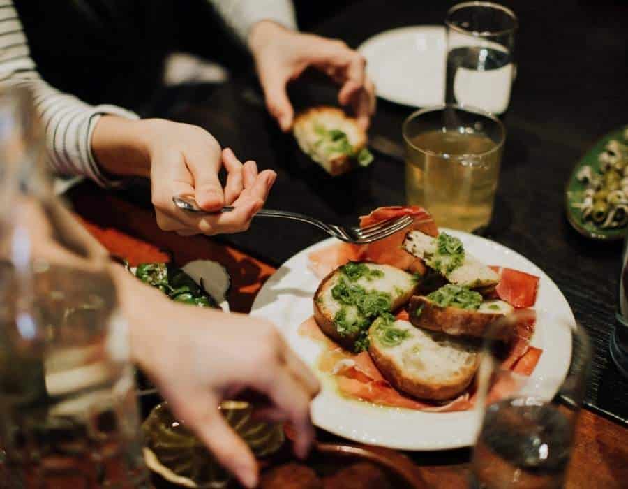 woman eating tapas during nyc food tour