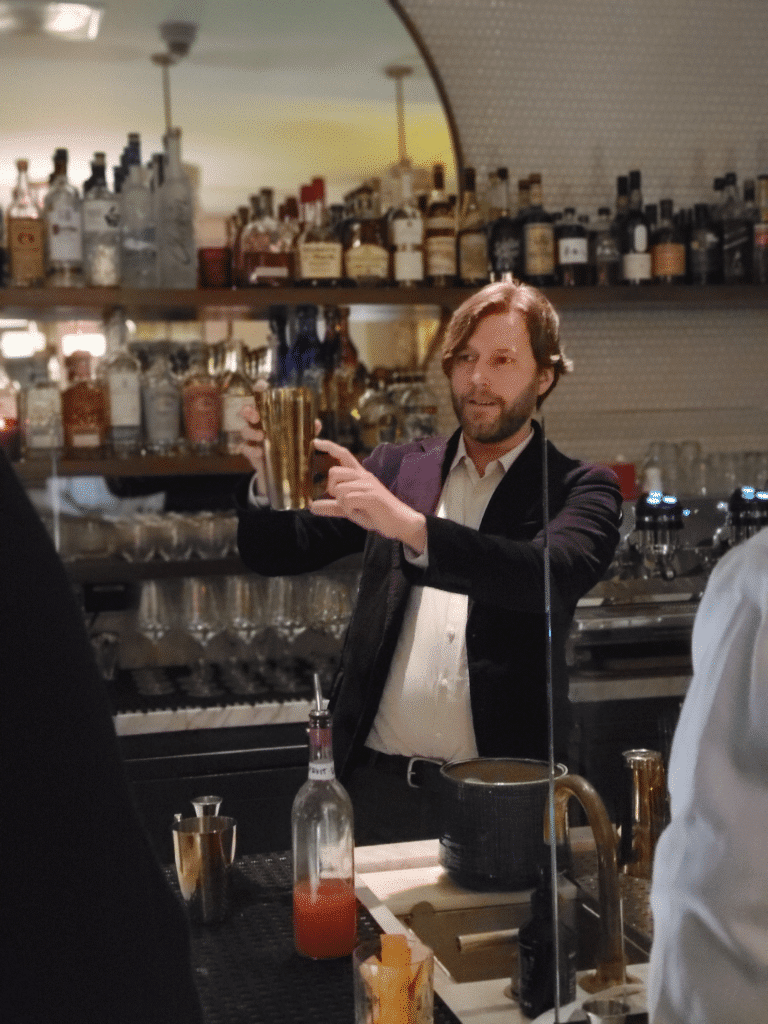 Bartender showing how much of shaker to pour into during a DTLA Interactive Meal at Cafe Basque