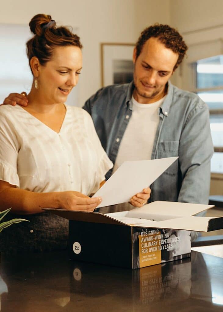 couple unboxing virtual client appreciation gift