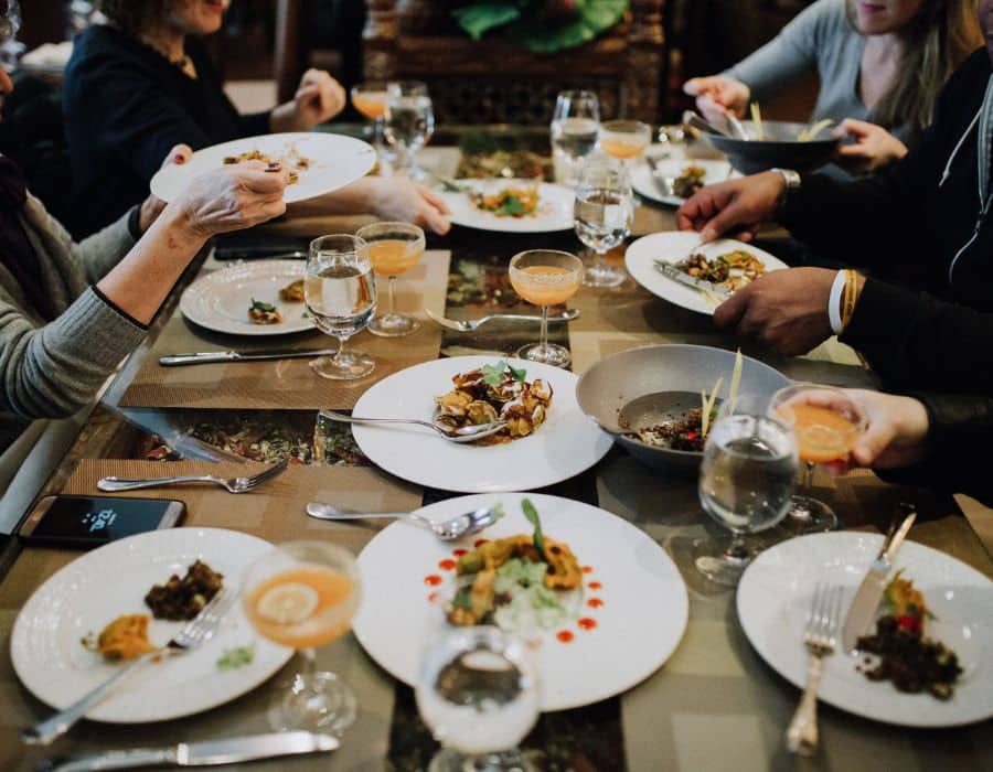 group eating at table of food during nyc food tour