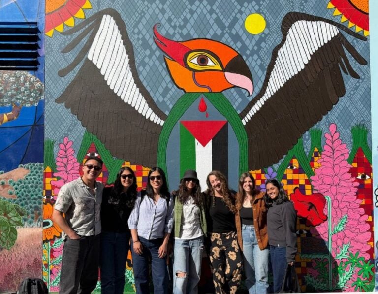 group in front of mural during mission district food tour