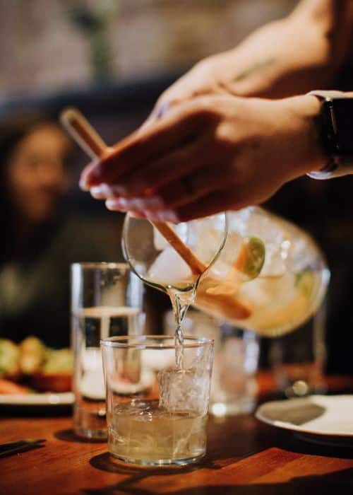 hand pouring white sangria during nyc east village food tour
