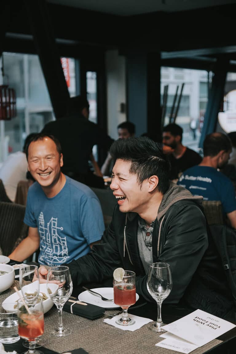 men laughing at table during seattle private dining event