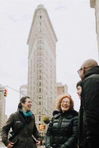 team standing in front of flatiron building during nyc team building event