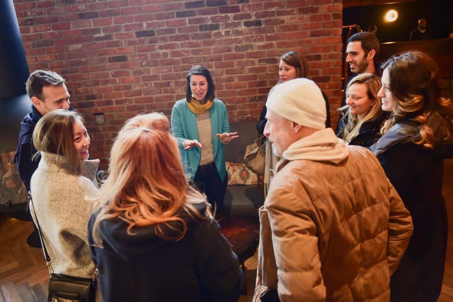 avital guide telling story during food tours, one of the best corporate holiday party ideas