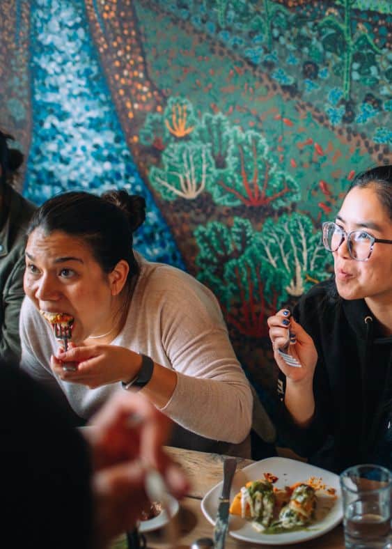 two women eating during walking food tour in san francisco