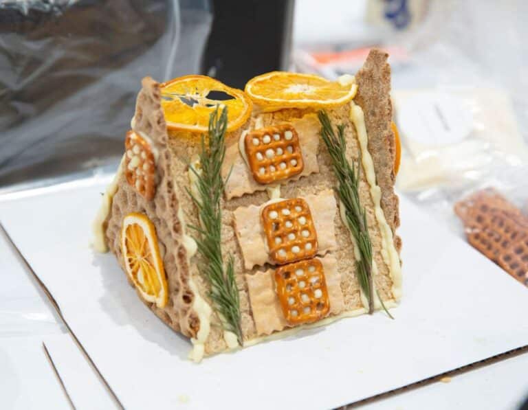 unique a-frame charcuterie house with pretzels, oranges, and rosemary