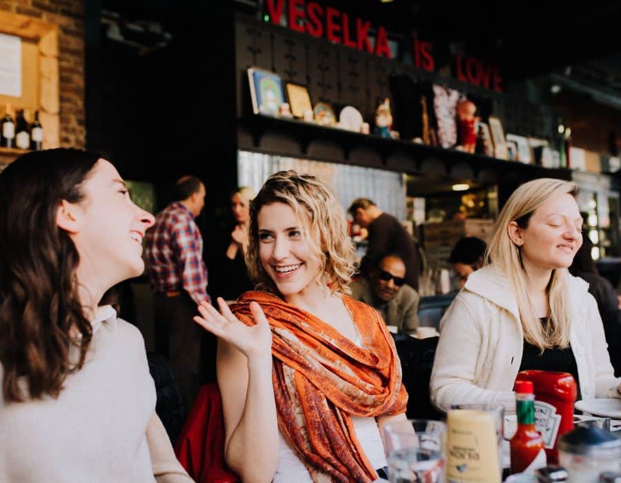 women chatting at restaurant during nyc food tour