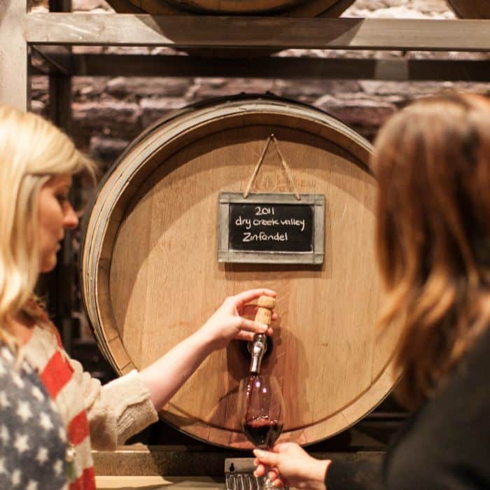women pouring wine from barrel during sf bachelorette party food tour