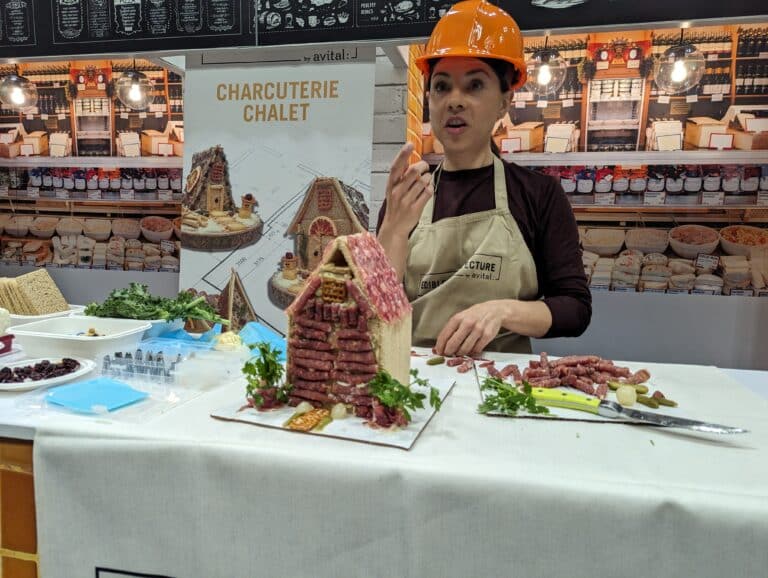 Chef brooke with creminelli meat salami decorating a charcuterie chalet