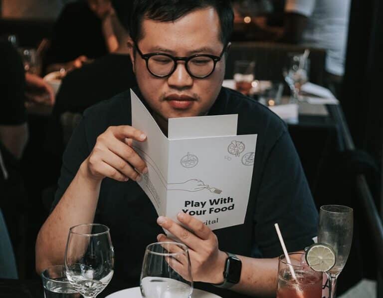 man looking at avital menu during private dining experience