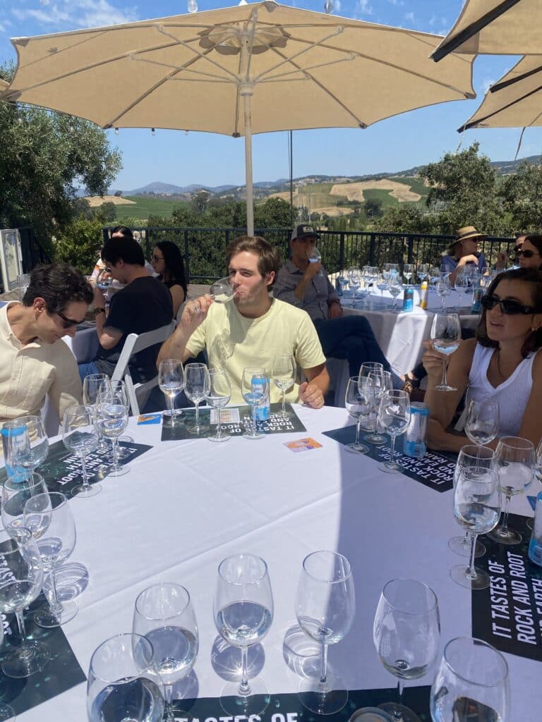man drinking water from wine glass during guided water tasting