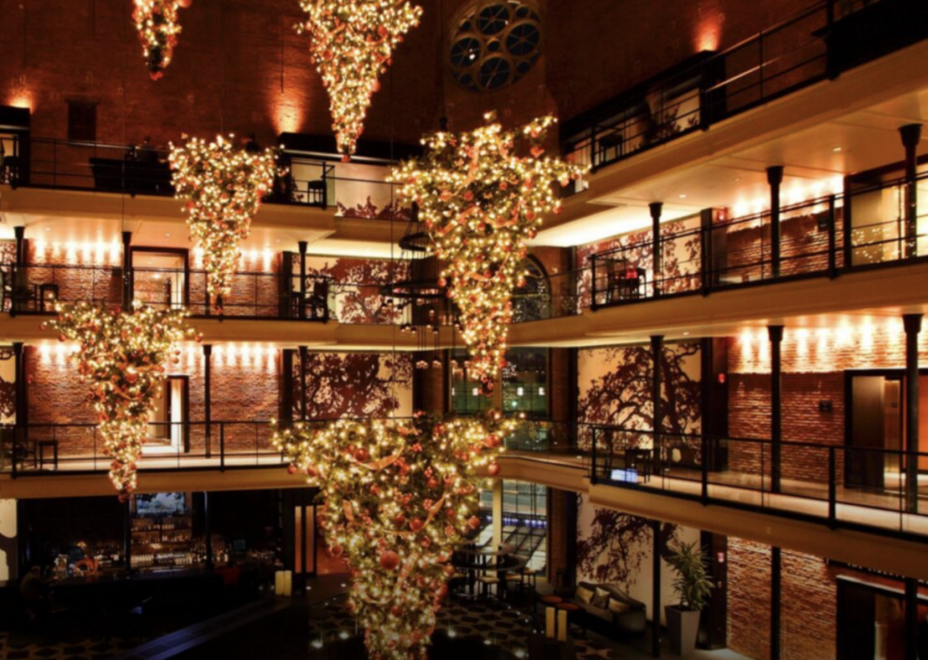 Christmas trees hang upside down from the ceiling of the Liberty Hotel