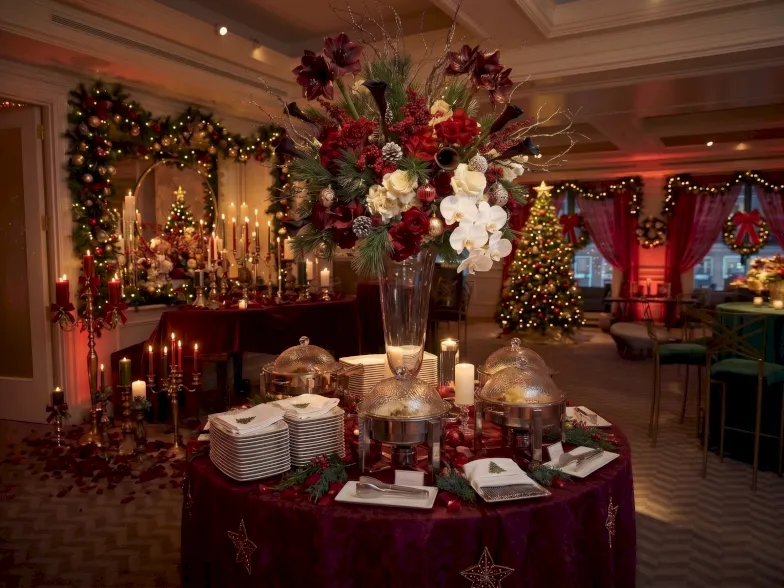 The Boston Harbor Hotel is decorated for a holiday party with flowers and green and red