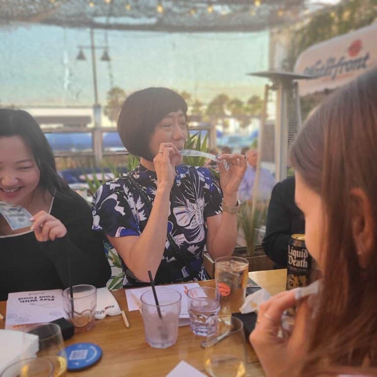 women eating money during interactive meal in la