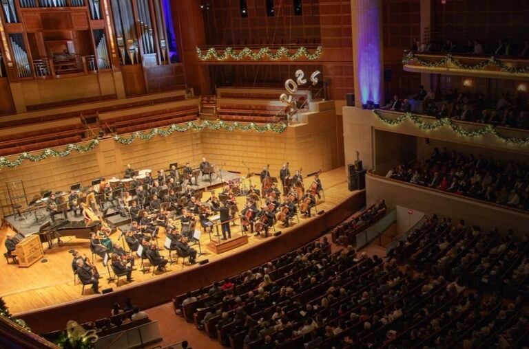 A big band sits onstage and plays holiday favorite pop songs