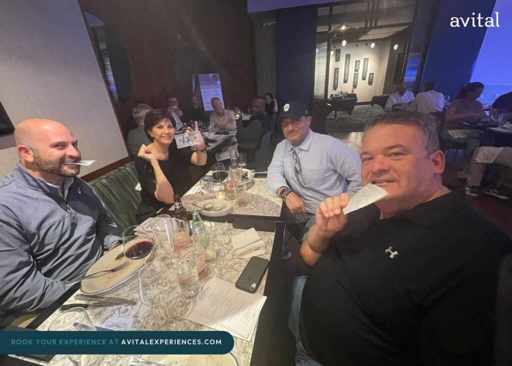 group biting edible money during avital group dining event