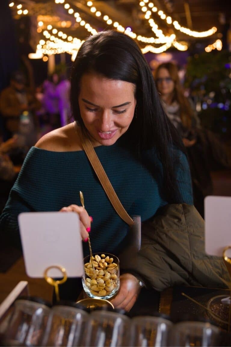 woman stirring nuts during spiced nut mixing bar