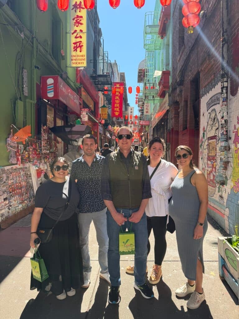 group standing in front of ross alley during chinatown food tour with avital