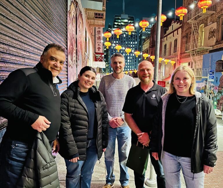 group standing in front of lanterns in chinatown