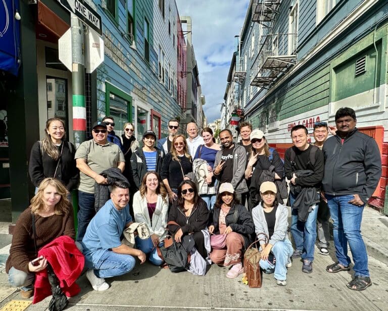 large group posing in ross alley during chinatown food tour