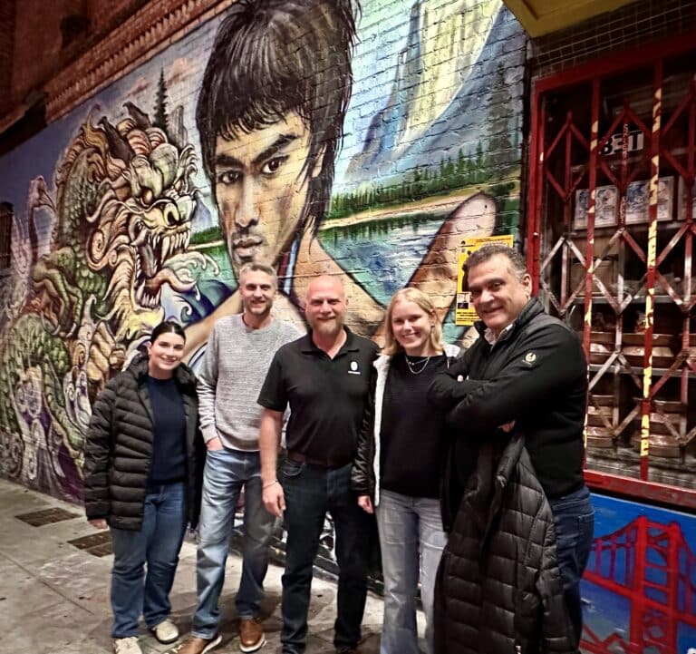 small group in front of mural during chinatown food tour