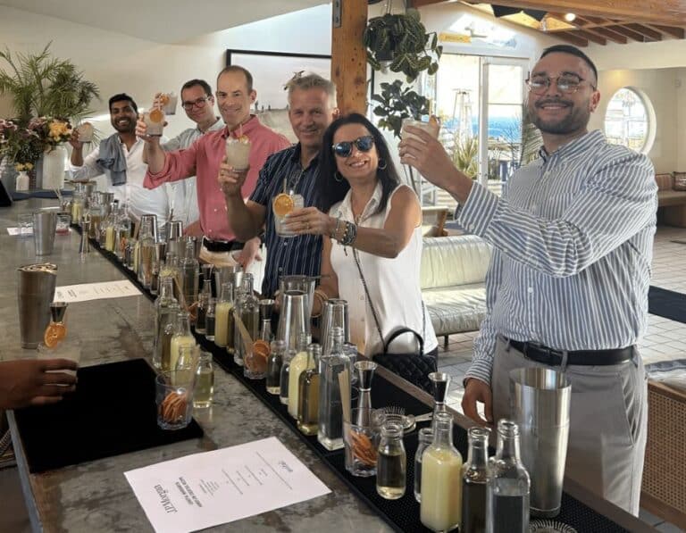 group at bar making cocktails during la private dining event