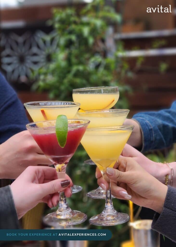 hands toasting cocktails during la group dining