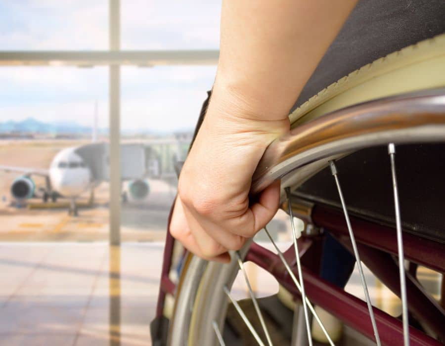 man in wheelchair looking out window at sfo airport