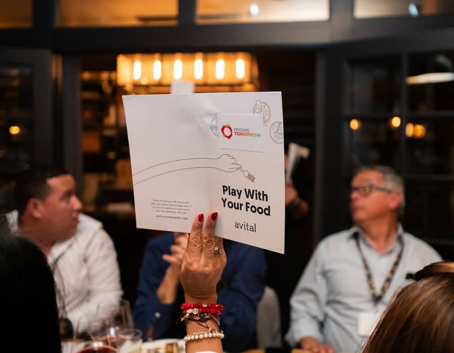 woman holding up avital interactive meal menu in los angeles