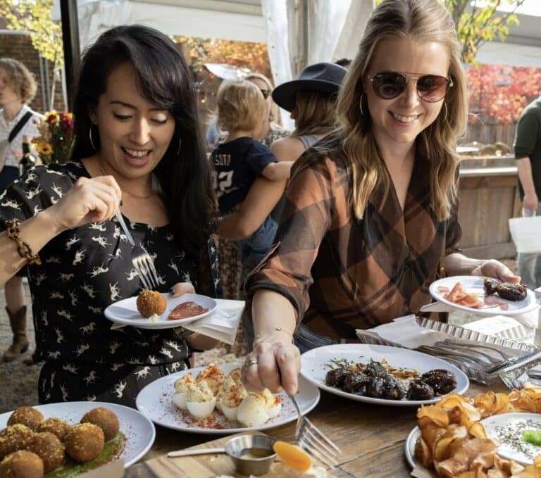 two women enjoying food at st vincent wine in washington dc during large group private dining event