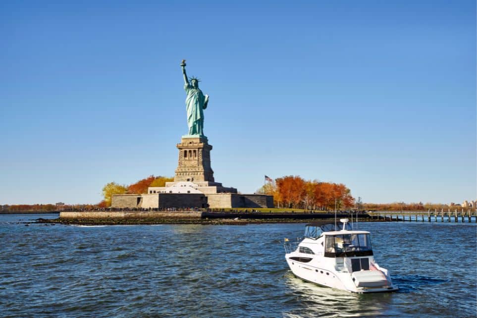 boat parked in front of statue of liberty
