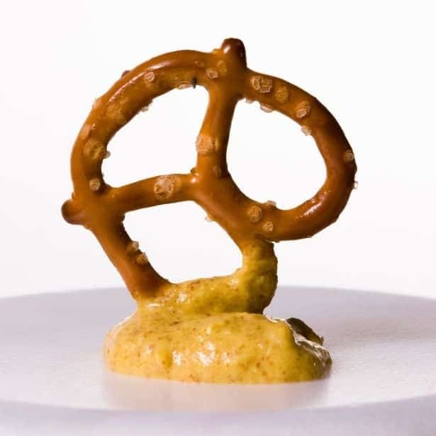 pretzel dipped in mustard